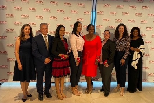 A group of women stand with Hany Ayoub, deputy vice president of Manhattanville Development group, at the Women Builder's Council awards ceremony.