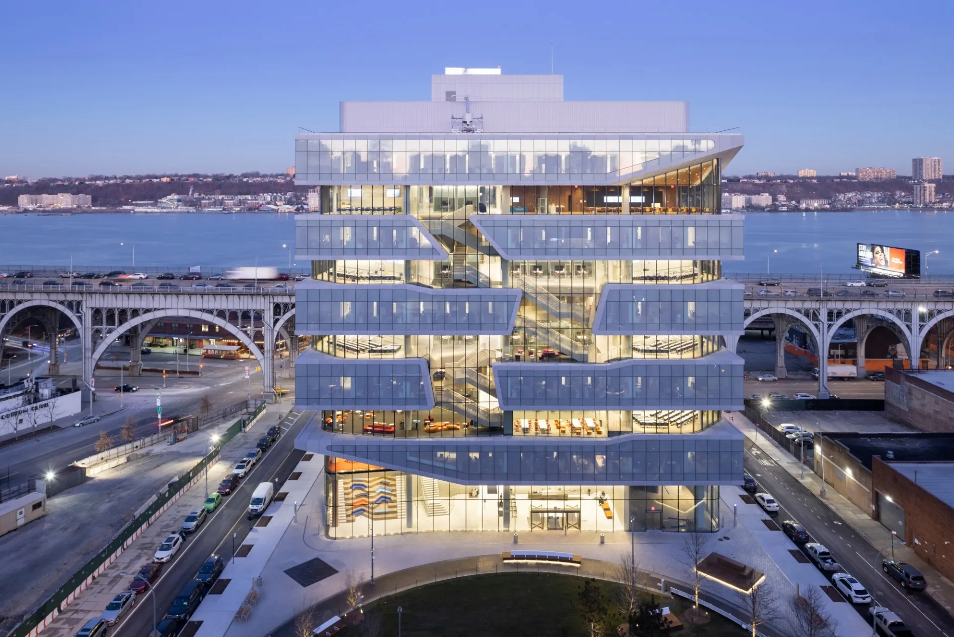 A view of Henry Kravis Hall during dusk, with the Viaduct in the background.