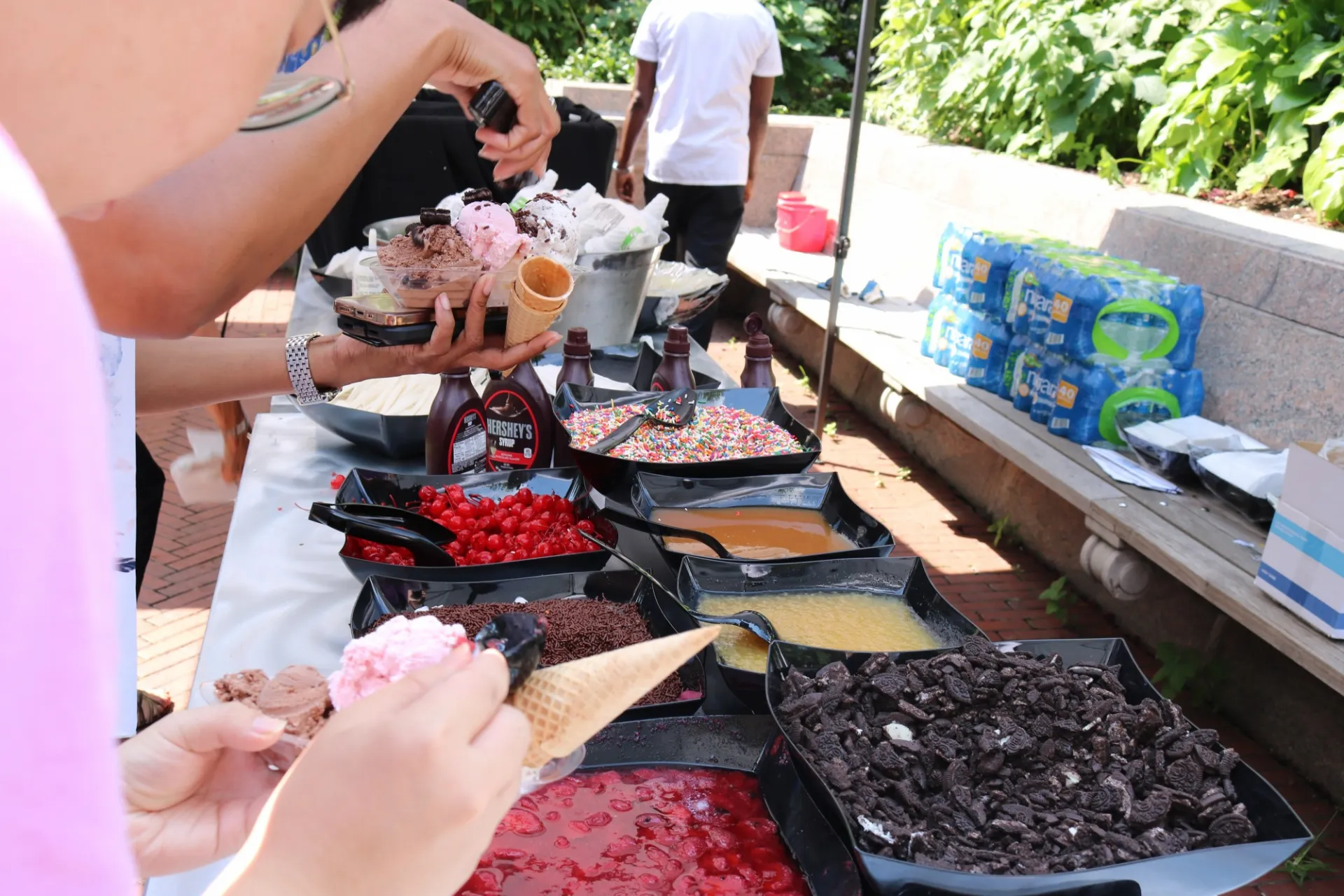 The ice cream topping station, with sprinkles, caramel, cherries, oreos, and chocolate sauce.