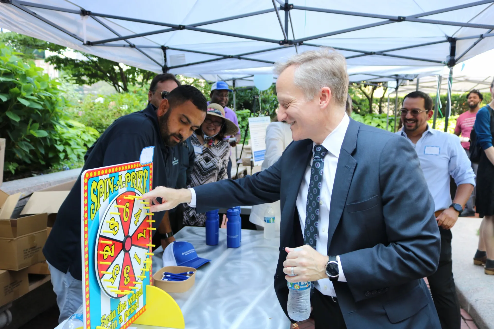 David M. Greenberg spins a prize wheel at one of the tables at the event.