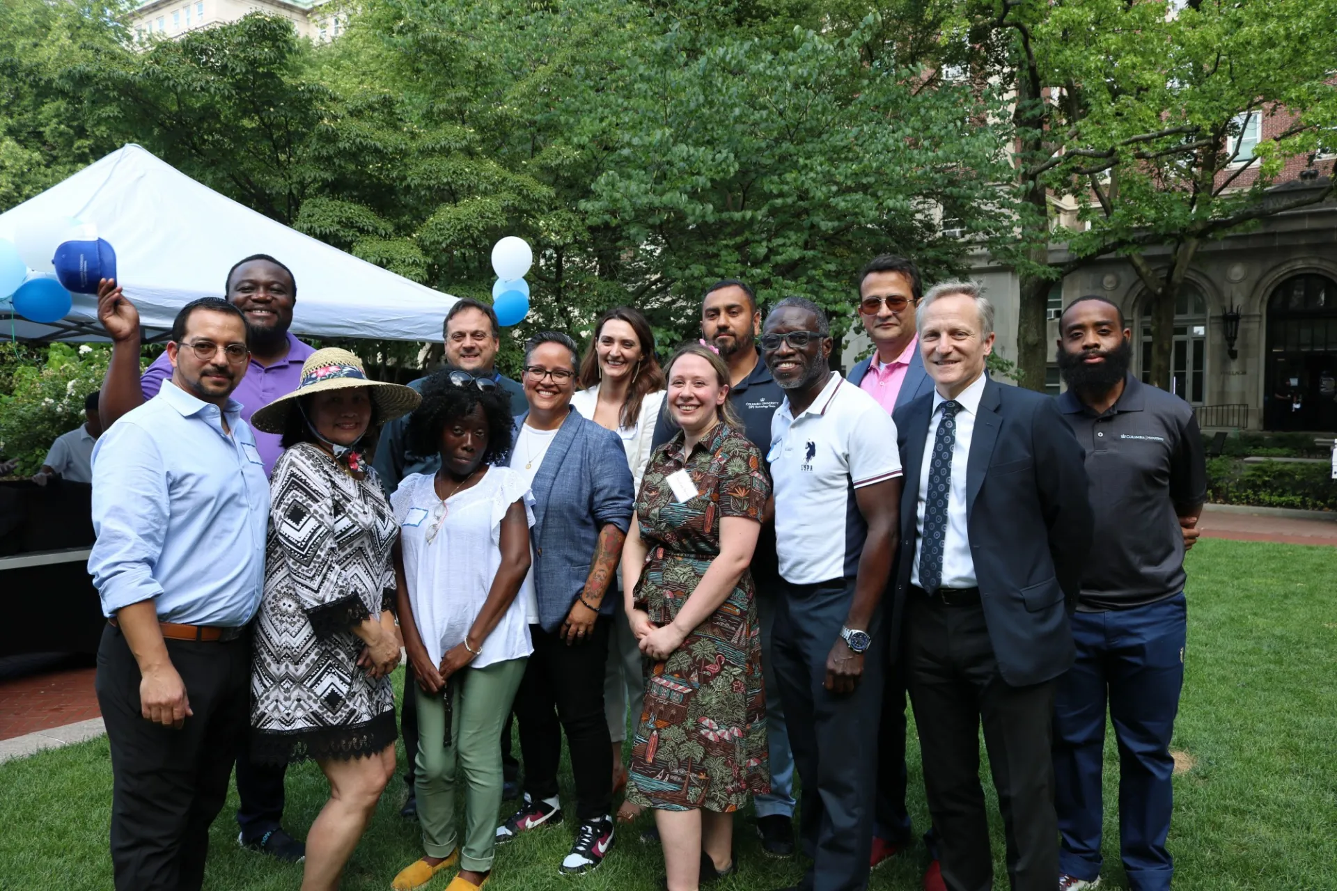 A group of Facilities and Operations staff stand together at the ice cream social event.